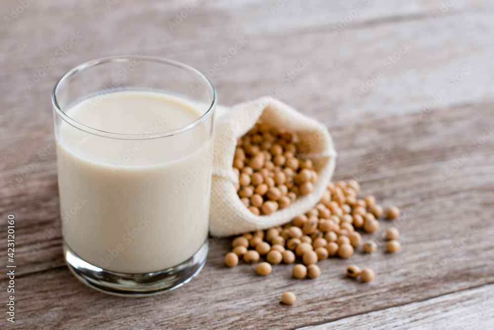 Glass of soy milk isolated on wooden table background. Glass of soy milk isolated on wooden table background.