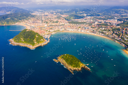 Scenic view from drone of Spanish town of San Sebastian (Donostia) on southern coast of Bay of Biscay on sunny summer day, Basque Country..