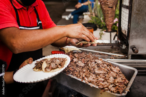 cooking Mexican tacos with beef, traditional street food in Mexico city