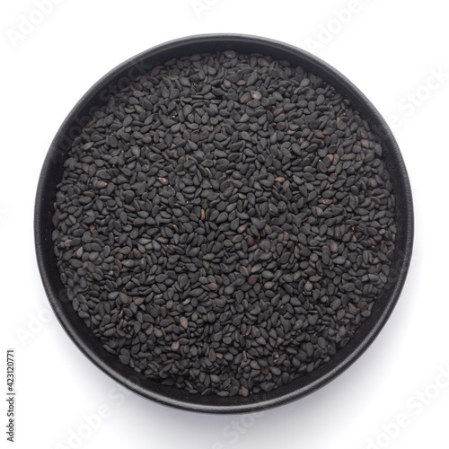 Macro Close up of Organic Black Sesame seeds(Sesamum indicum) or Black Til with shell inside a black ceramic bowl