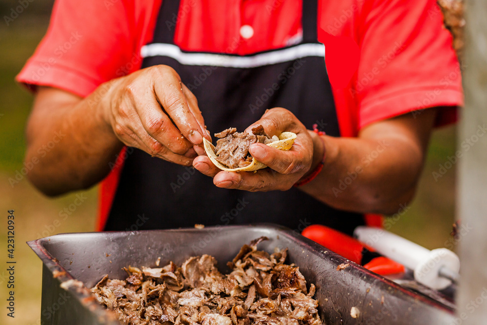 cooking Mexican tacos with beef, traditional street food in Mexico city