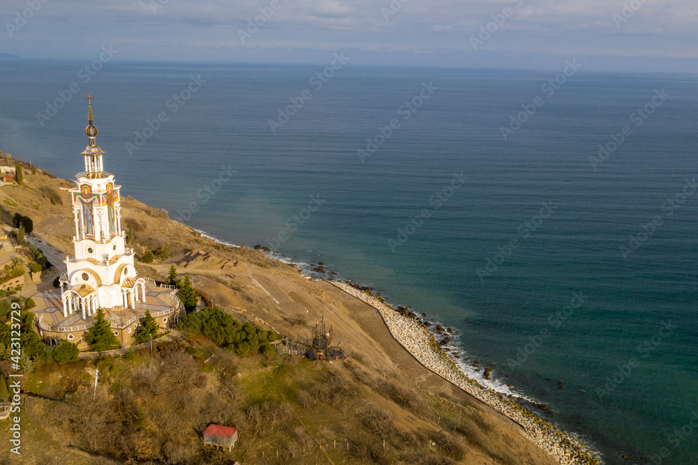 Coast of the Crimea peninsula, rocky mountains, aerial view Temple-lighthouse of St. Nicholas the Wonderworker (Russia, Malorechenskoye)