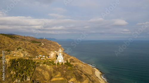 Coast of the Crimea peninsula, rocky mountains, aerial view Temple-lighthouse of St. Nicholas the Wonderworker (Russia, Malorechenskoye)