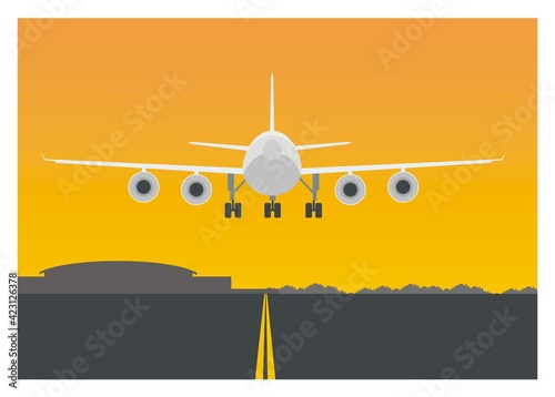 Airplane landing on an airport runway. Backside view.