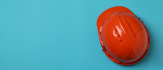 Hard hat on blue background, space for text