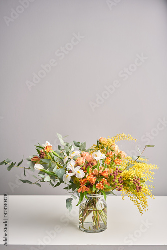 Finished flower arrangement in a vase for home. Flowers bunch, set for interior. Fresh cut flowers for decoration home. European floral shop. Delivery fresh cut flower.