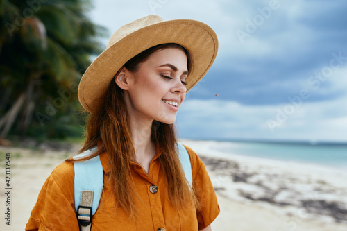 romantic woman in sundress hat with backpack on nature travel tourism