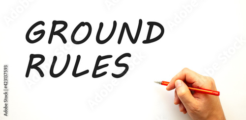 Hand writing GROUND RULES with pen. Isolated on white background.