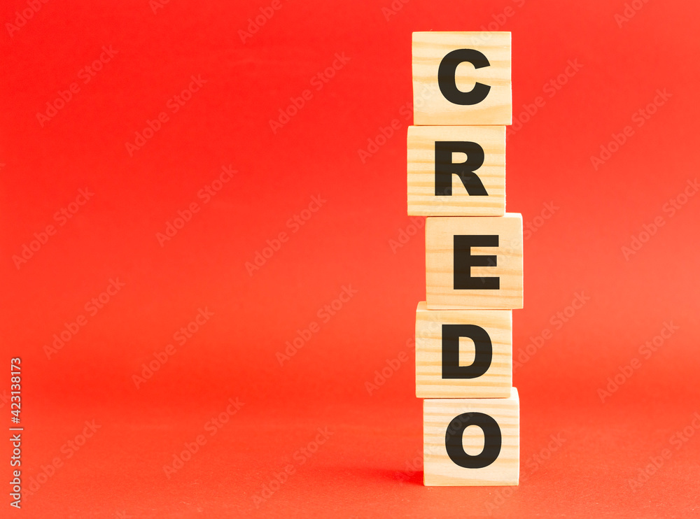 Wooden cubes with word CREDO. Wooden cubes on a red background. Free space on the left. Wooden cubes with word CREDO. Wooden cubes on a red background. Free space on the left.