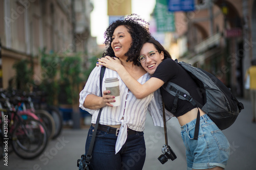  Girls traveling around Europe together. Two tourist women on street.