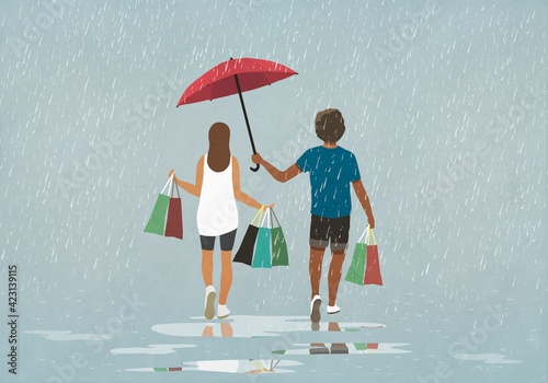Husband holding umbrella over wife with shopping bags in rain
 photo