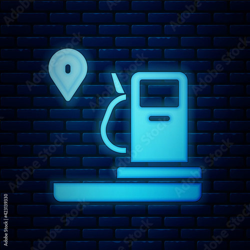 Glowing neon Location and petrol or gas station icon isolated on brick wall background. Car fuel symbol. Gasoline pump. Vector