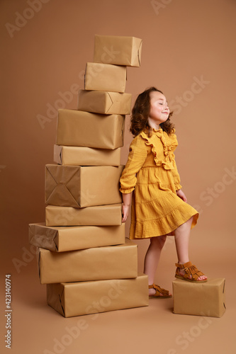 Girl leaning against a high pile of gifts