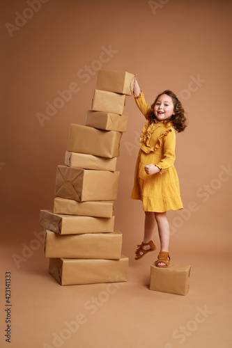 Girl pointing at a stack of gifts