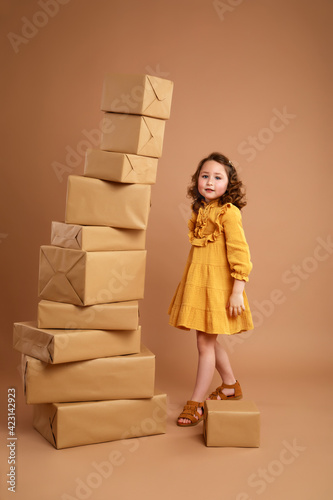 Girl with a stack of gifts for the holiday