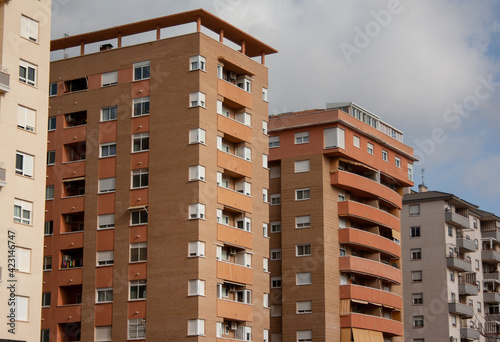 Row of buildings with balconies built with different shapes and colors in Elda, Alicante.
