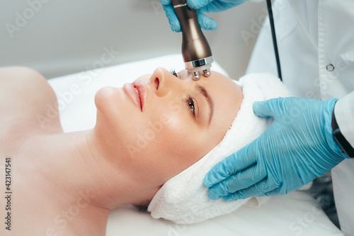 Beautiful woman getting facial skincare treatment in a cosmetic beauty clinic