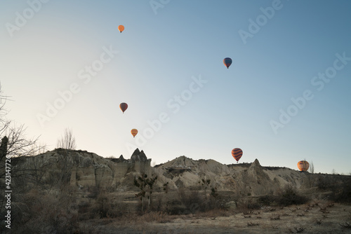 Hot air balloons flying over spectacular Cappadocia, Goreme at sunrise. Turkey