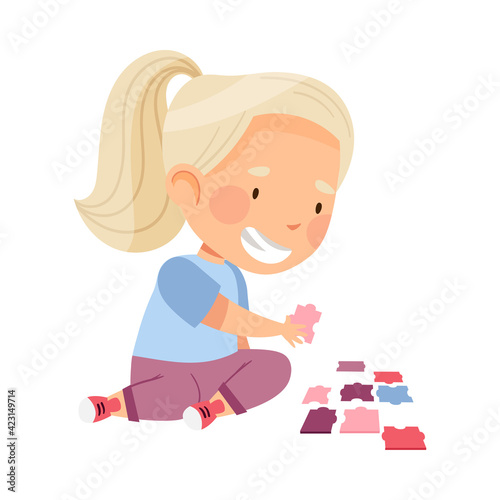 Little Blond Girl Playing Jigsaw Puzzle on the Floor Vector Illustration © Happypictures