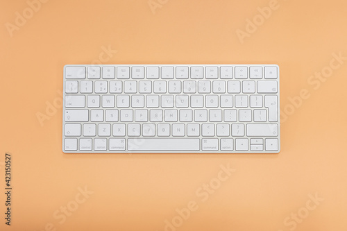 Top view keyboard on orange background