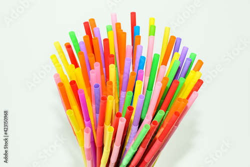 Lots of multicolored plastic disposable cocktail straws. Colorful accessory and decoration for a cocktail and drinks party.