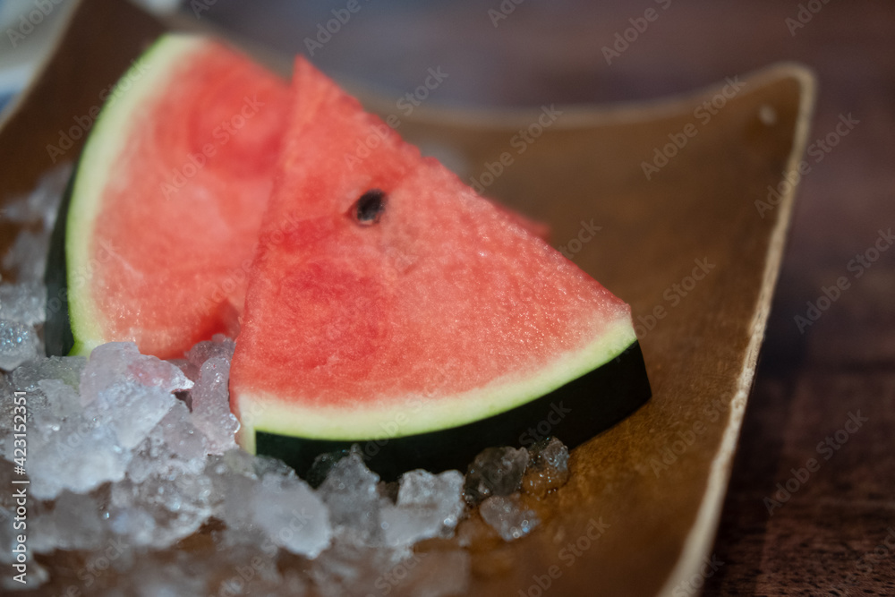 Watermelon slices served on ice in a plate Watermelon slices served on ice in a plate