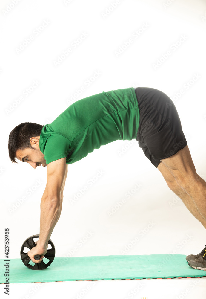 man with Ab roll Bodytone for abdominal strengthening. Small wheel that allows exercises to strengthen the core. on white background.. man with Ab roll Bodytone for abdominal strengthening. Small wheel that allows exercises to strengthen the core. on white background..