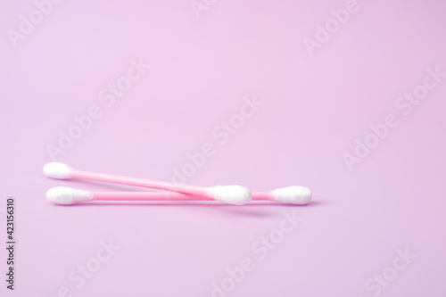 Cotton swabs isolated on pink background. Beauty and hygiene concept.
