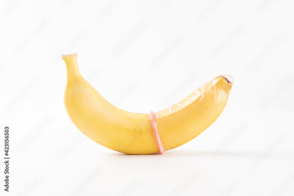 Condom and banana on a white background close-up. Condom and banana on a white background close-up.