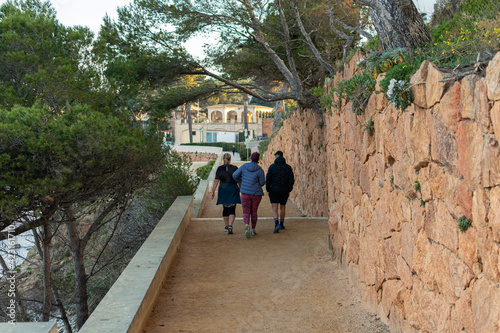 Family walking along the Camino de Ronda from S'Agaró to Sa Conca