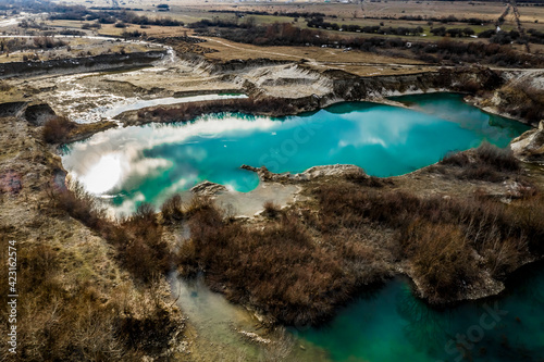 Turquoise lake among the trees. North Caucasus, Russia. 