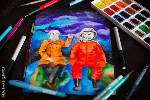 Watercolor picture of the first Russian cosmonaut Gagarin and scientist Tsiolkovsky, palette, brushes and markers photo