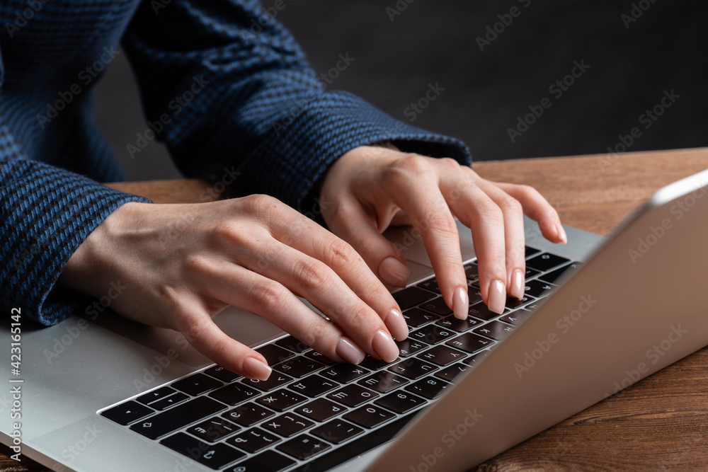 Close up woman hands lying on laptop keyboard