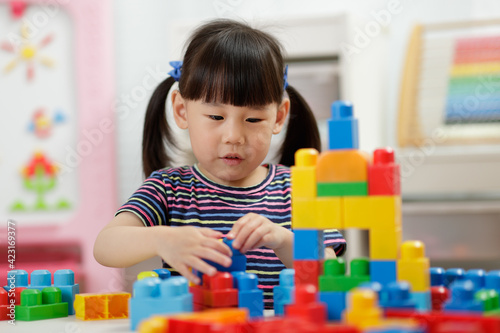  young girl playing creative toy blocks for homeschooling