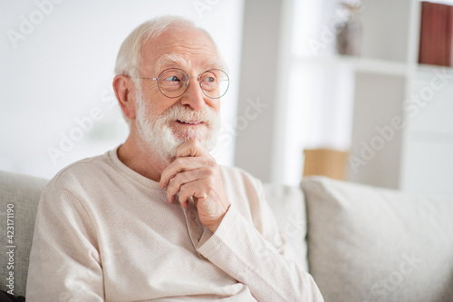 Photo of thoughtful funny age pensioner sleepwear spectacles arm chin inside indoors home room
