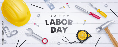 Happy labor day horizontal banner with realistic yellow helmet and tools on light wooden background