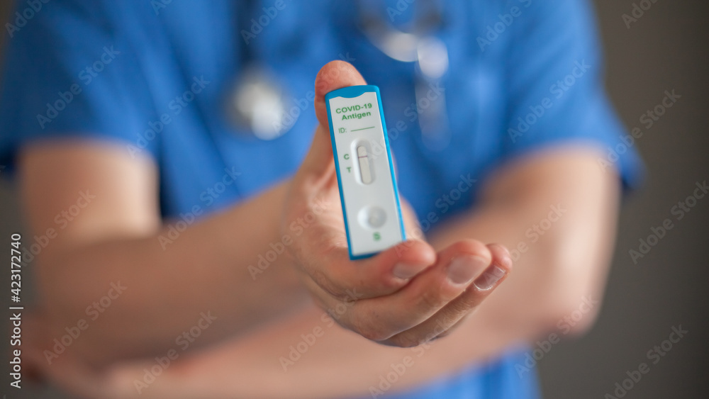 Fototapeta premium The doctor holds a negative antigen test Covid-19 in his hand 