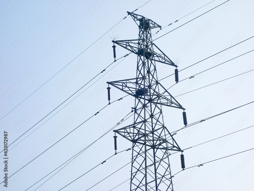 Close up of power poles and towers in the background of blue sky Close up of power poles and towers in the background of blue sky