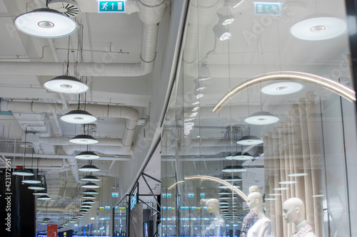 Air duct, wiring and plumbing in the mall. Air conditioner pipe, wiring pipe, and plumbing pipe system. Building interior concept. Ceiling lamp light with opened light.