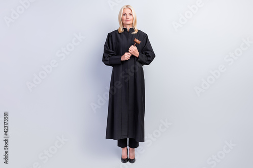 Full body photo of professional calm old woman hold gavel justice law isolated on grey color background