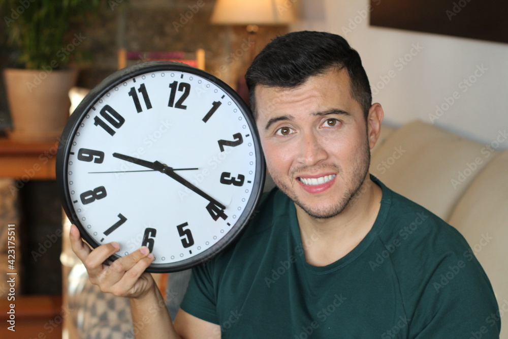 Man holding large clock experimenting pressure Man holding large clock experimenting pressure