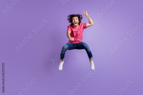 Full length photo of cool crazy young guy dressed pink outfit jumping riding horse isolated purple color background