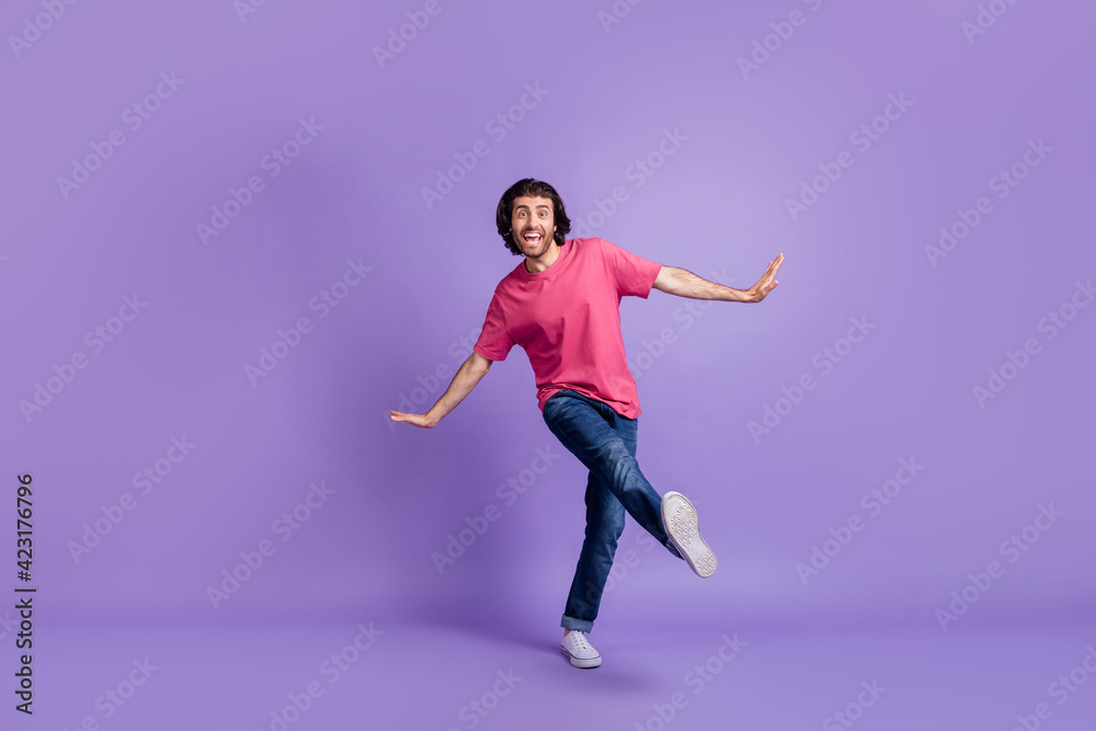 Full length photo of charming cute young guy dressed pink outfit dancing walking isolated purple color background