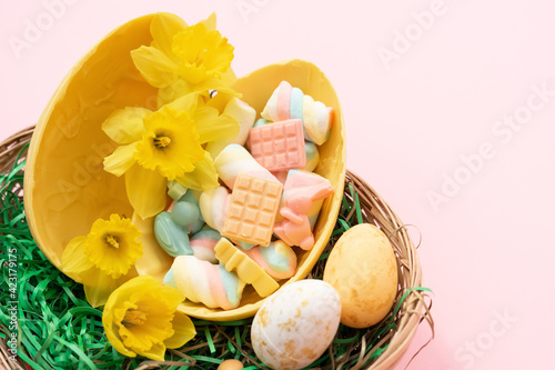 Yellow Easter chocolate egg full of candies. 