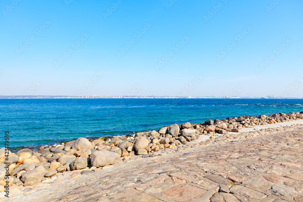 Seaside boulders and berth balustrade . Stones on the Baltic Sea coast 