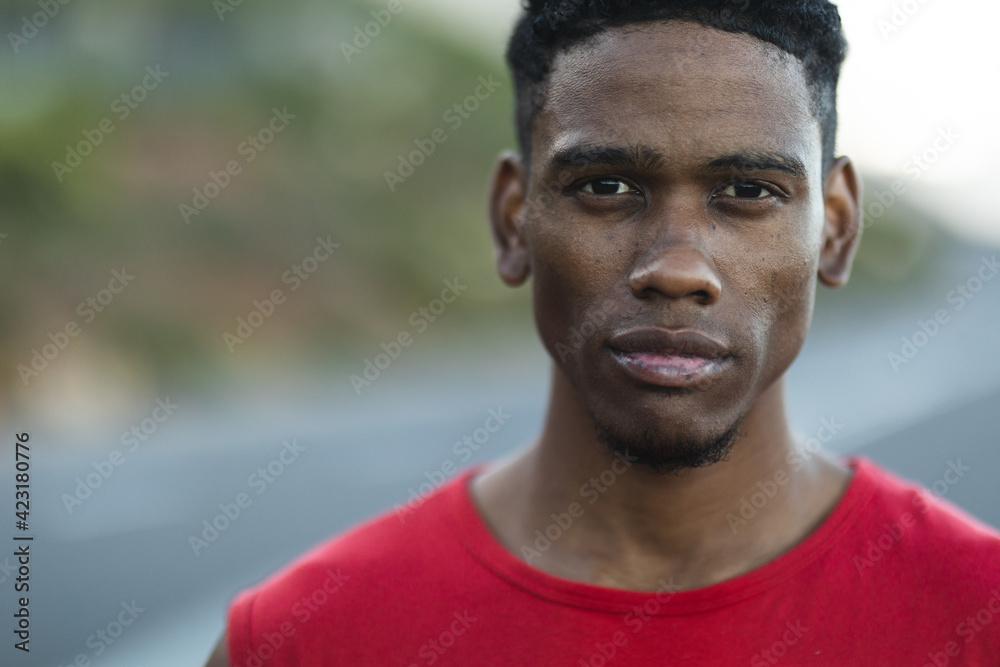 Portrait of fit african american man exercising outdoors on a coastal road to camera Portrait of fit african american man exercising outdoors on a coastal road to camera
