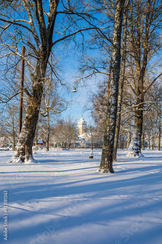 Winter view of the park and church on the background, Tammisaari, Finland © hivaka