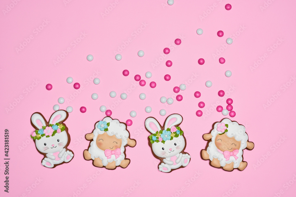 Easter bunny and lamb cookies over pink pastel background Easter bunny and lamb cookies over pink pastel background