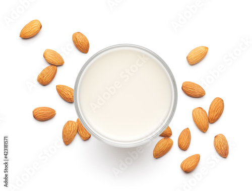 Photos Glass of almond milk with raw almonds over white background - flat lay