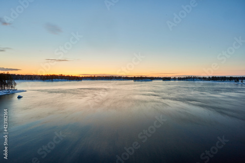 a landscape of sunset by a large lake